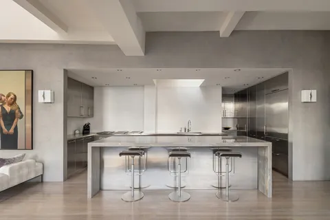 a kitchen with a table and chairs