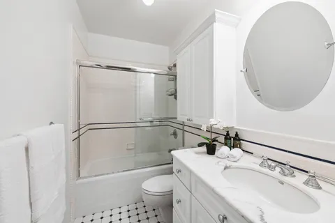 a bathroom with a sink toilet and shower