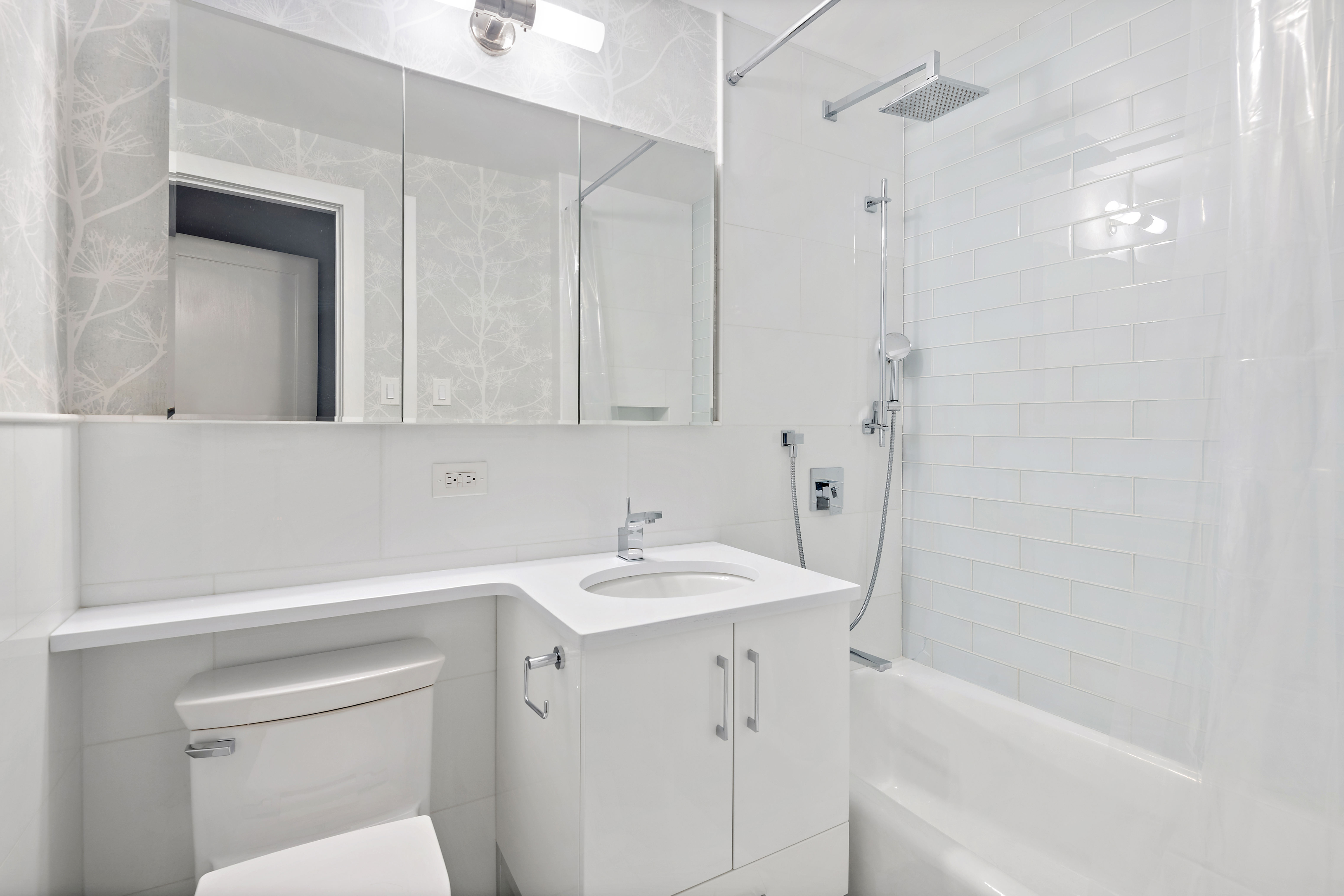 440 East 56th Street, Unit 8C Manhattan, NY 10022 - Photo 5 of 14 a bathroom with a sink a toilet and shower