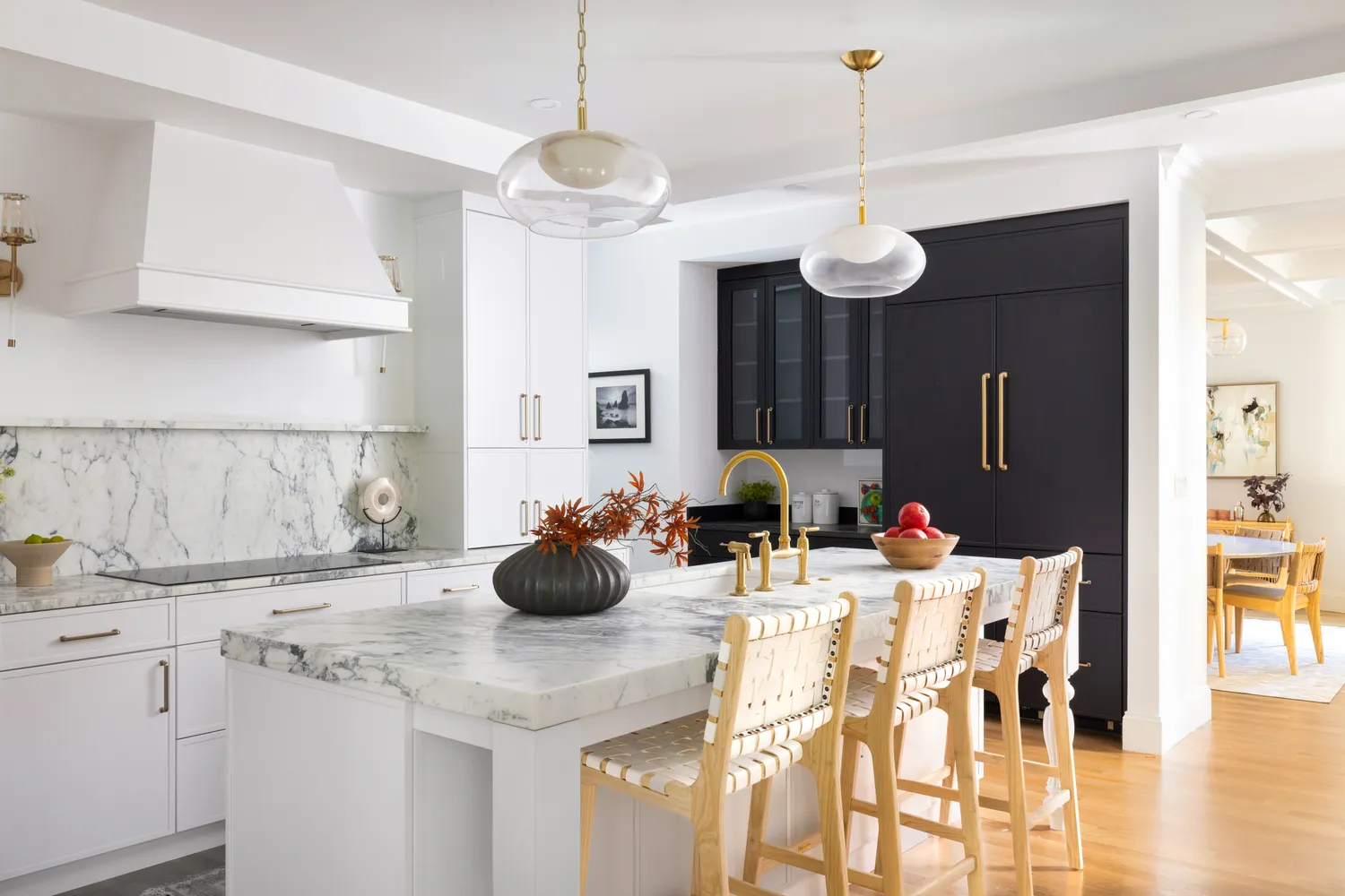 a kitchen with a sink a chandelier and living room view
