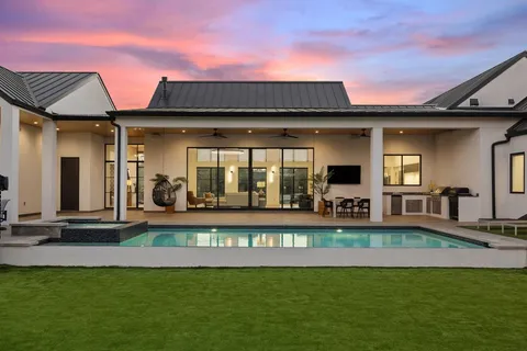 a view of a house with swimming pool and porch