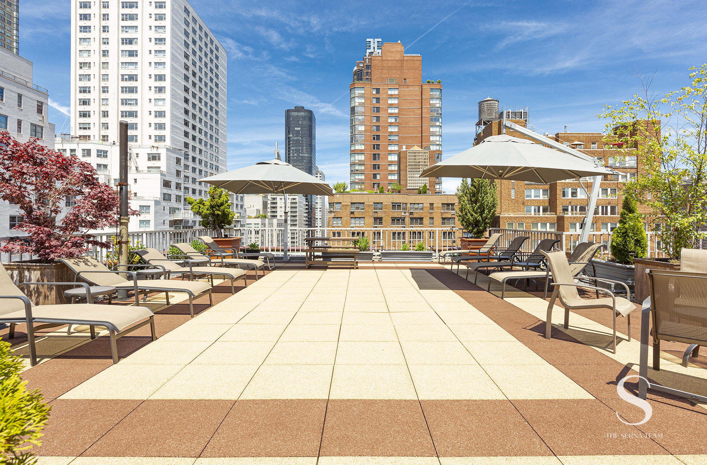 301 East 62nd Street, Unit 5E Manhattan, NY 10065 - Photo 13 of 15 a view of a patio with dining table and chairs under an umbrella