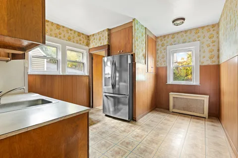 a kitchen with stainless steel appliances granite countertop a refrigerator and a stove