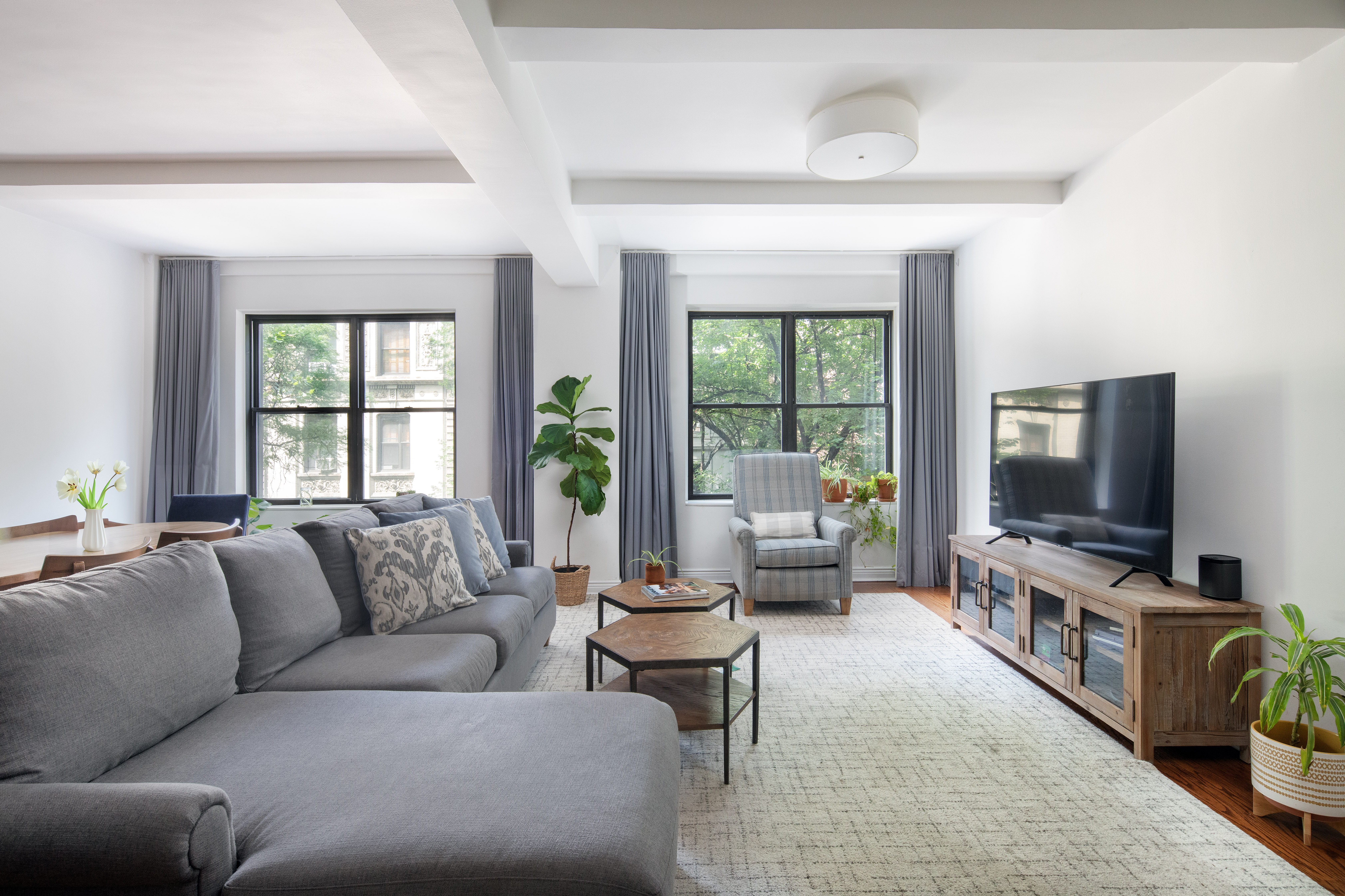 60 West 68th Street, Unit 5B Manhattan, NY 10023 - Photo 1 of 7 a living room with furniture and a flat screen tv