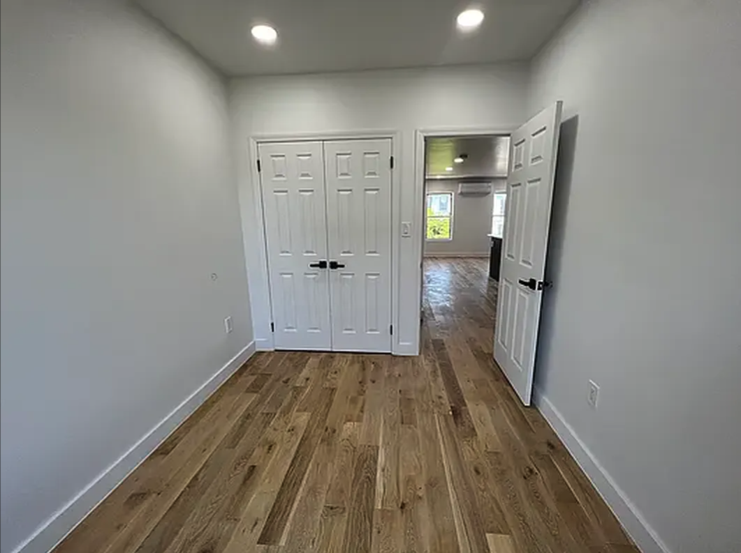 332 9th Street, Unit 4 Brooklyn, NY 11215 - Photo 4 of 8 a view of a hallway with wooden floor and a bathroom