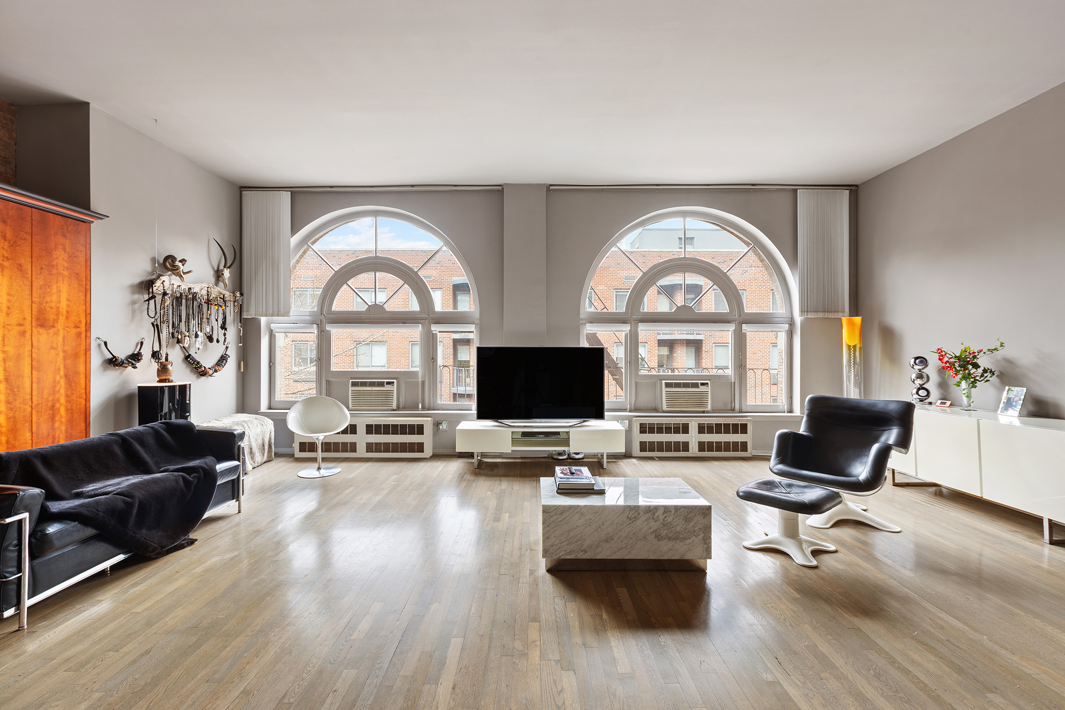 100 West 15th Street, Unit 4BC Manhattan, NY 10011 - Photo 2 of 9 a living room with furniture and a large window