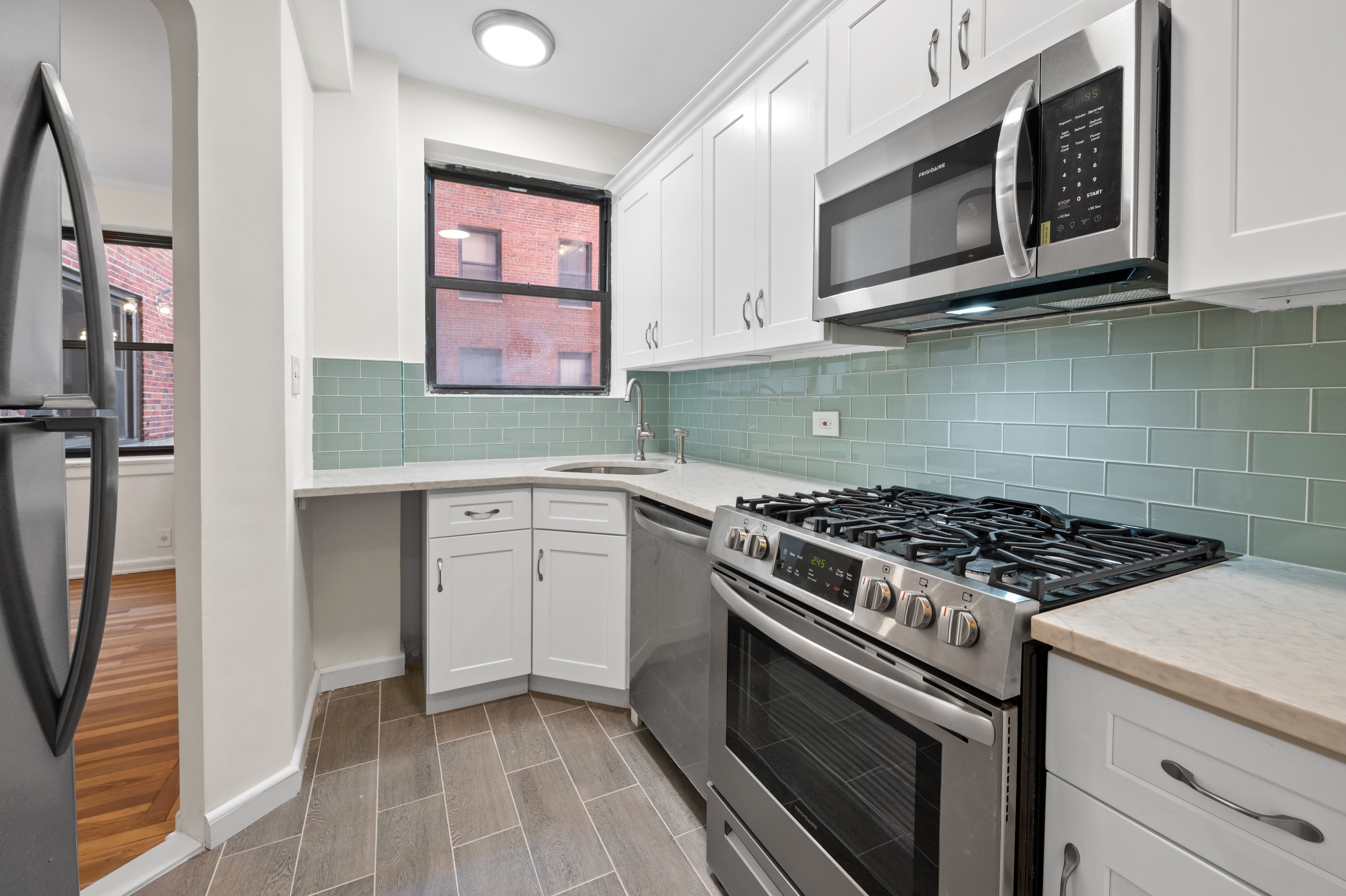 159-34 Riverside Drive West, Unit 3D Manhattan, NY 10032 - Photo 4 of 12 a kitchen with cabinets appliances and a sink