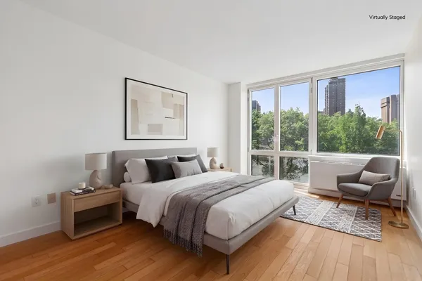 a bedroom with a bed and a large window