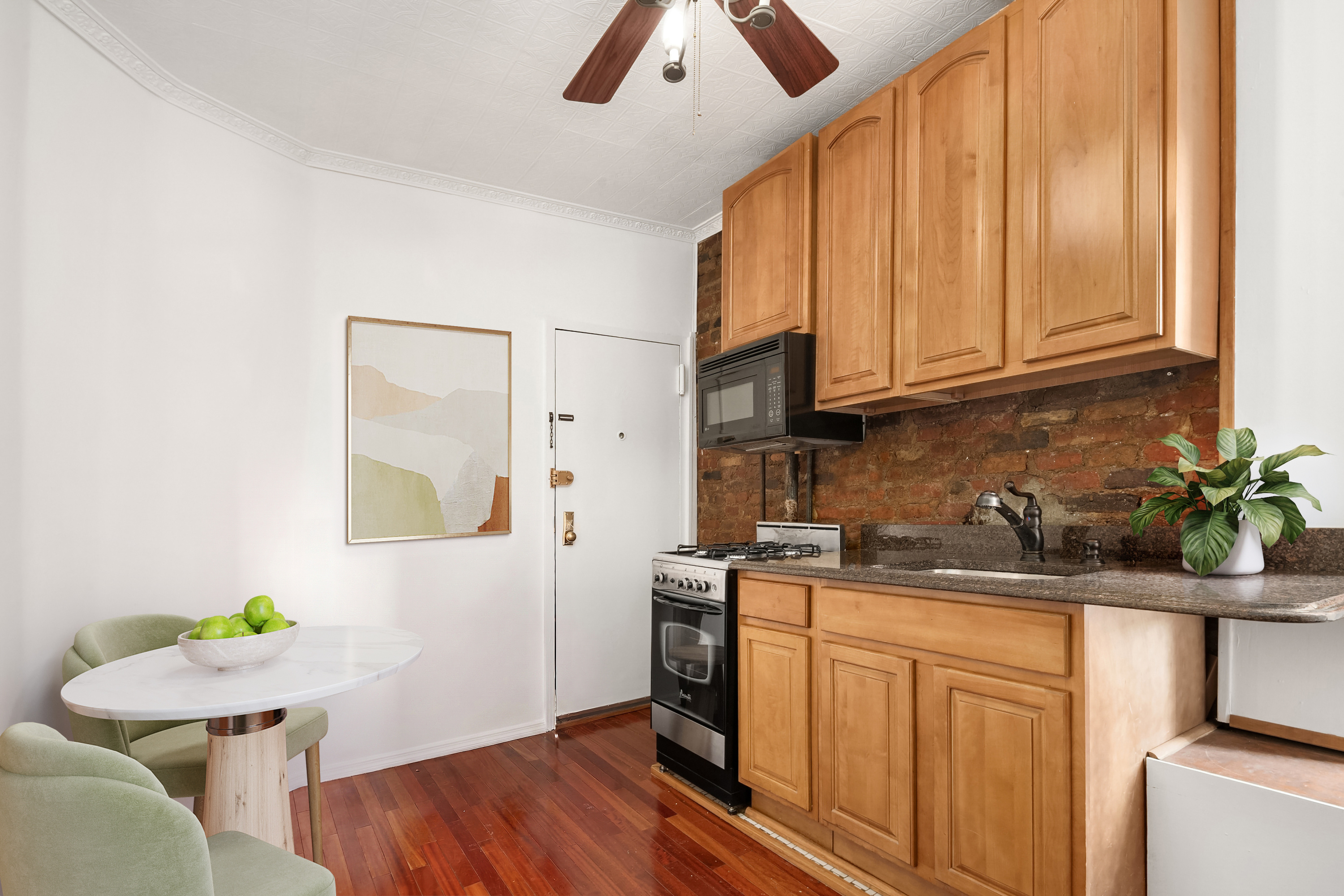 177 Thompson Street, Unit 22 Manhattan, NY 10012 - Photo 3 of 5 a kitchen with a sink cabinets and wooden floor