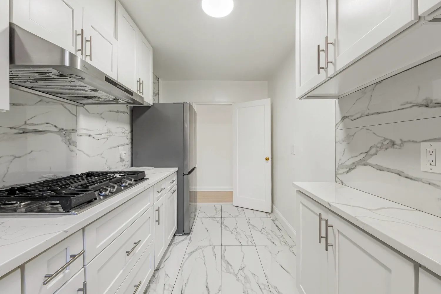 a kitchen with granite countertop a stove and a refrigerator