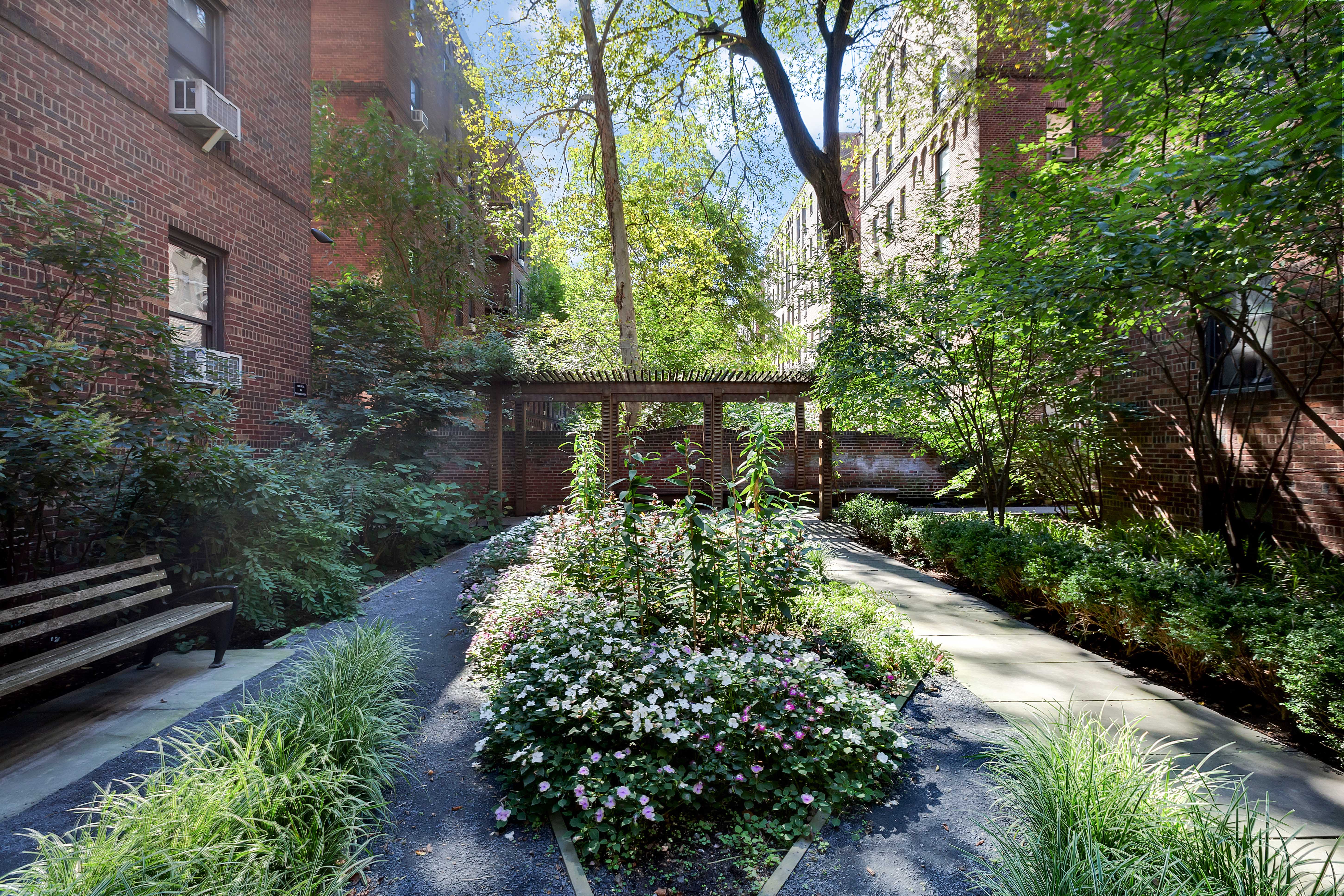 83-10 35th Avenue, Unit 6C Queens, NY 11372 - Photo 9 of 13 a view of a garden with pathway