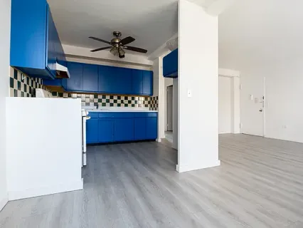 a view of kitchen with a sink and a refrigerator