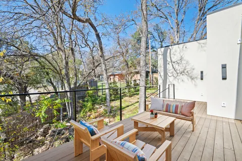 a view of a balcony with couch and wooden floor
