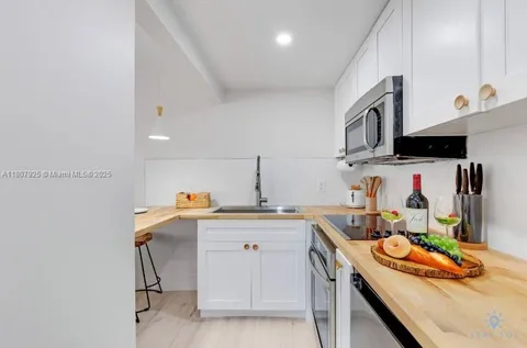 a kitchen that has a sink and cabinets in it