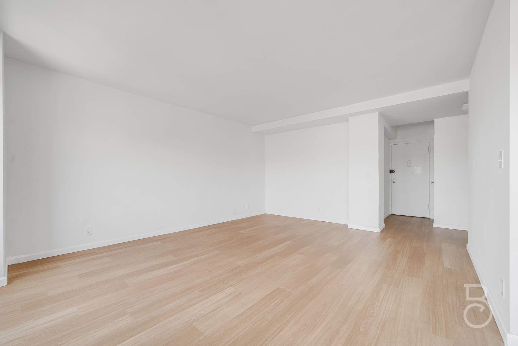 33-65 14th Street, Unit 5D Queens, NY 11106 - Photo 3 of 11 a view of empty room with wooden floor