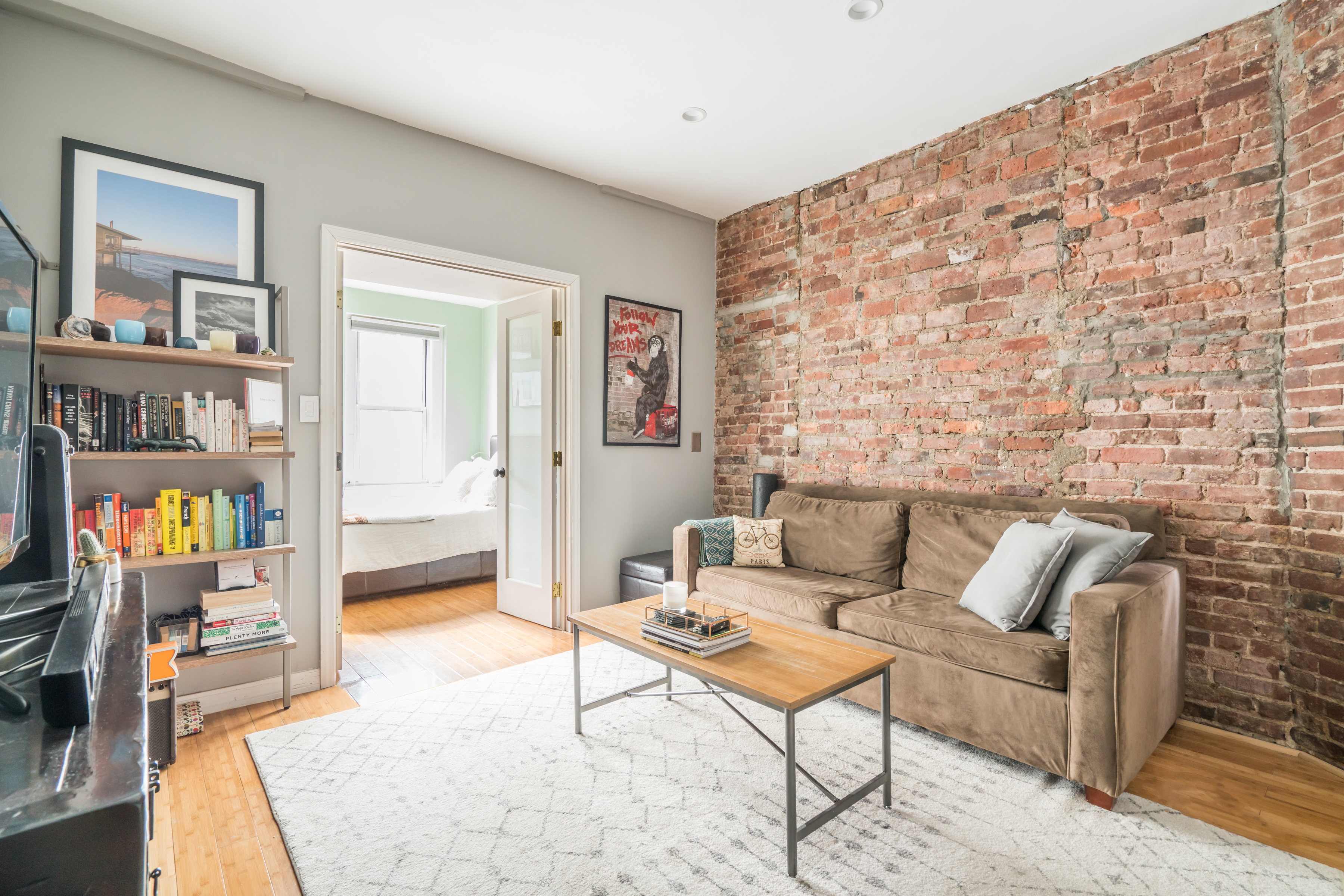 a living room with furniture and a book shelf