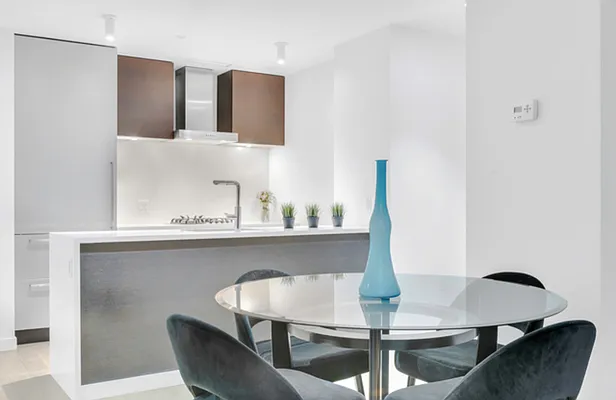 540 West 49th Street, Unit 206N Manhattan, NY 10019 - Photo 2 of 14 a dining room with furniture and wooden floor