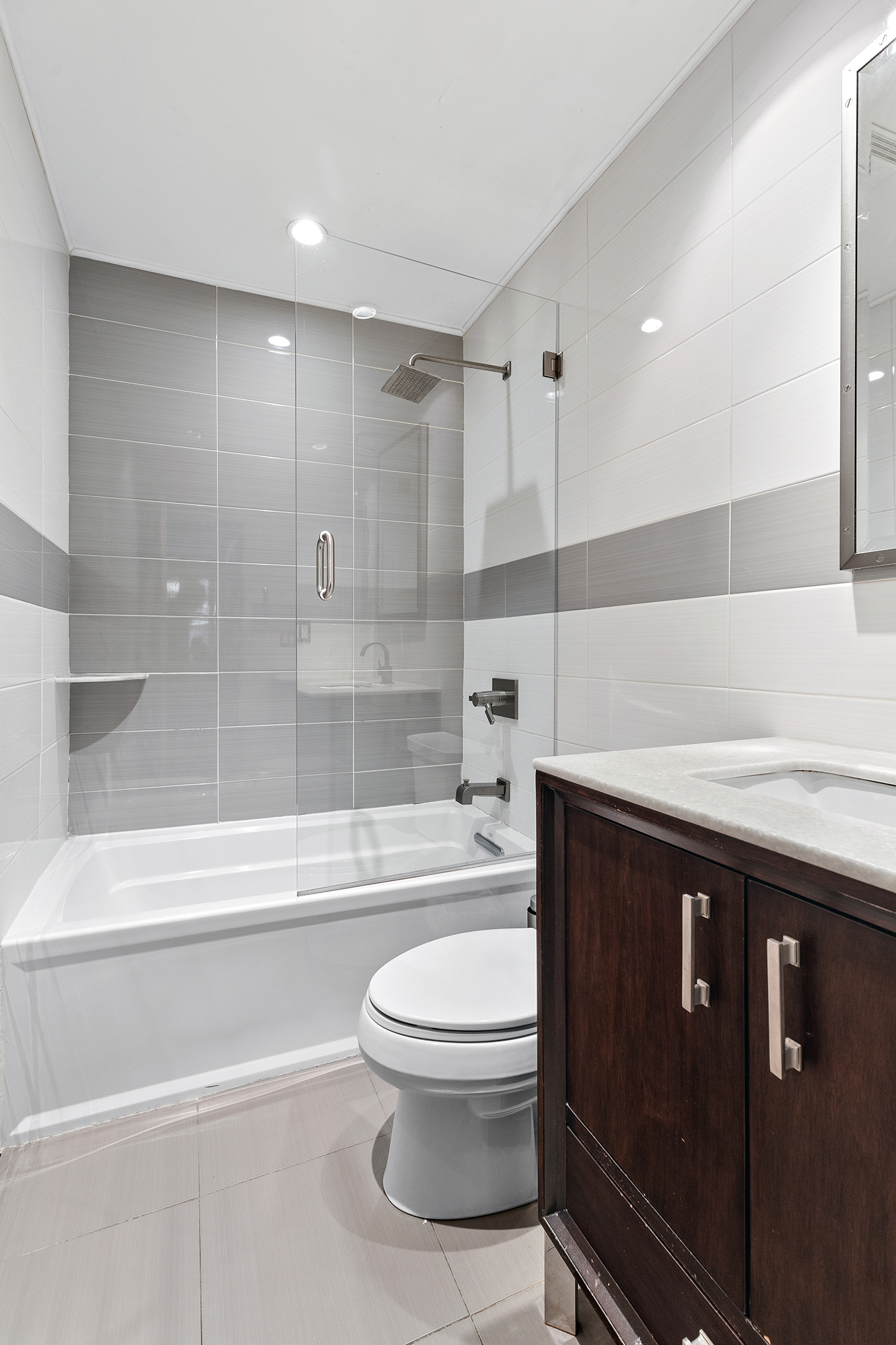 167 Grand Street, Unit 2 Brooklyn, NY 11249 - Photo 6 of 7 a bathroom with a toilet a sink and a shower