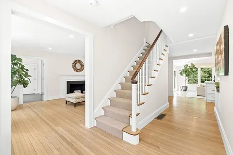 a view of entryway livingroom and hall with wooden floor