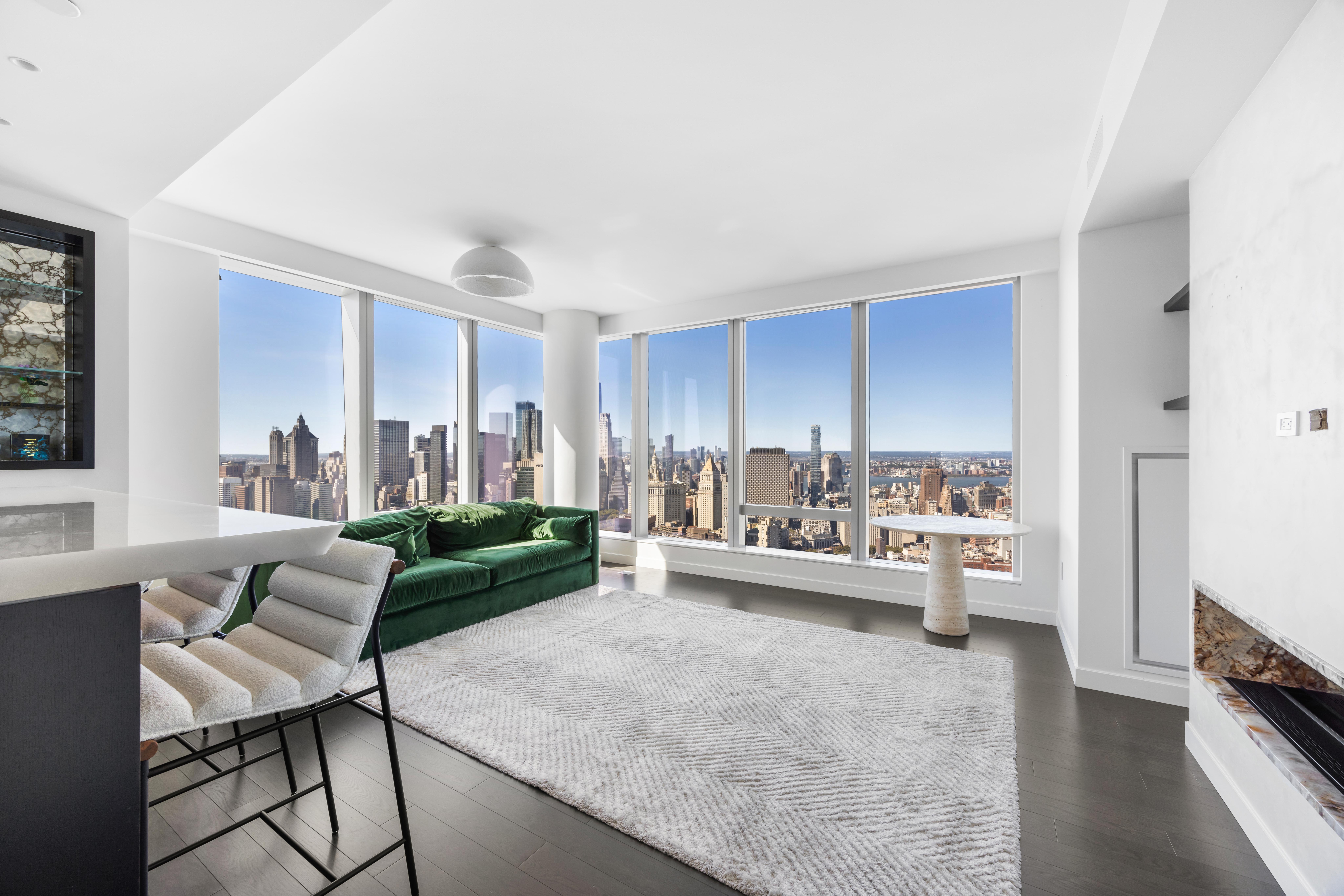 252 South Street, Unit 61A Manhattan, NY 10002 - Photo 2 of 29 a living room with furniture and a large window