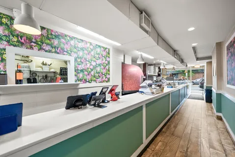 a kitchen with stainless steel appliances kitchen island granite countertop a sink and wooden floors