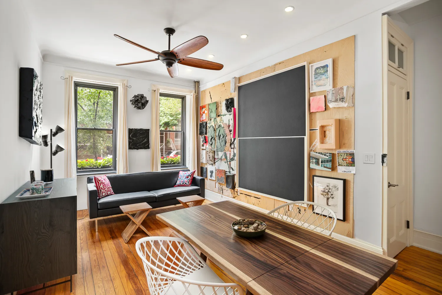 a living room with furniture flat screen tv and a large window