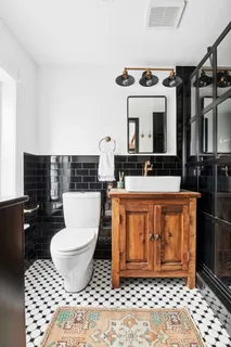 a bathroom with a sink toilet and mirror