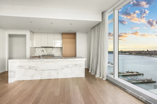 a large kitchen with kitchen island granite countertop a sink and cabinets