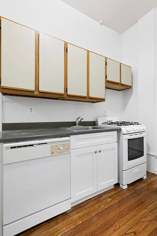 260 Gates Avenue, Unit 1C Brooklyn, NY 11238 - Photo 4 of 8 a kitchen with stainless steel appliances granite countertop a stove a sink and a microwave