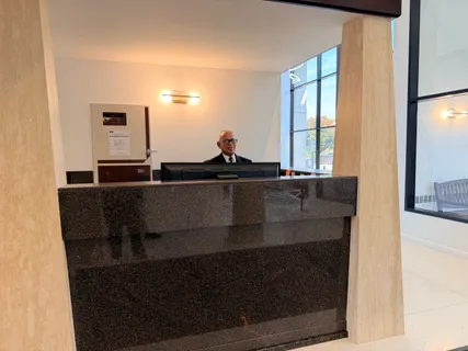 a living room with furniture a window and a glass door