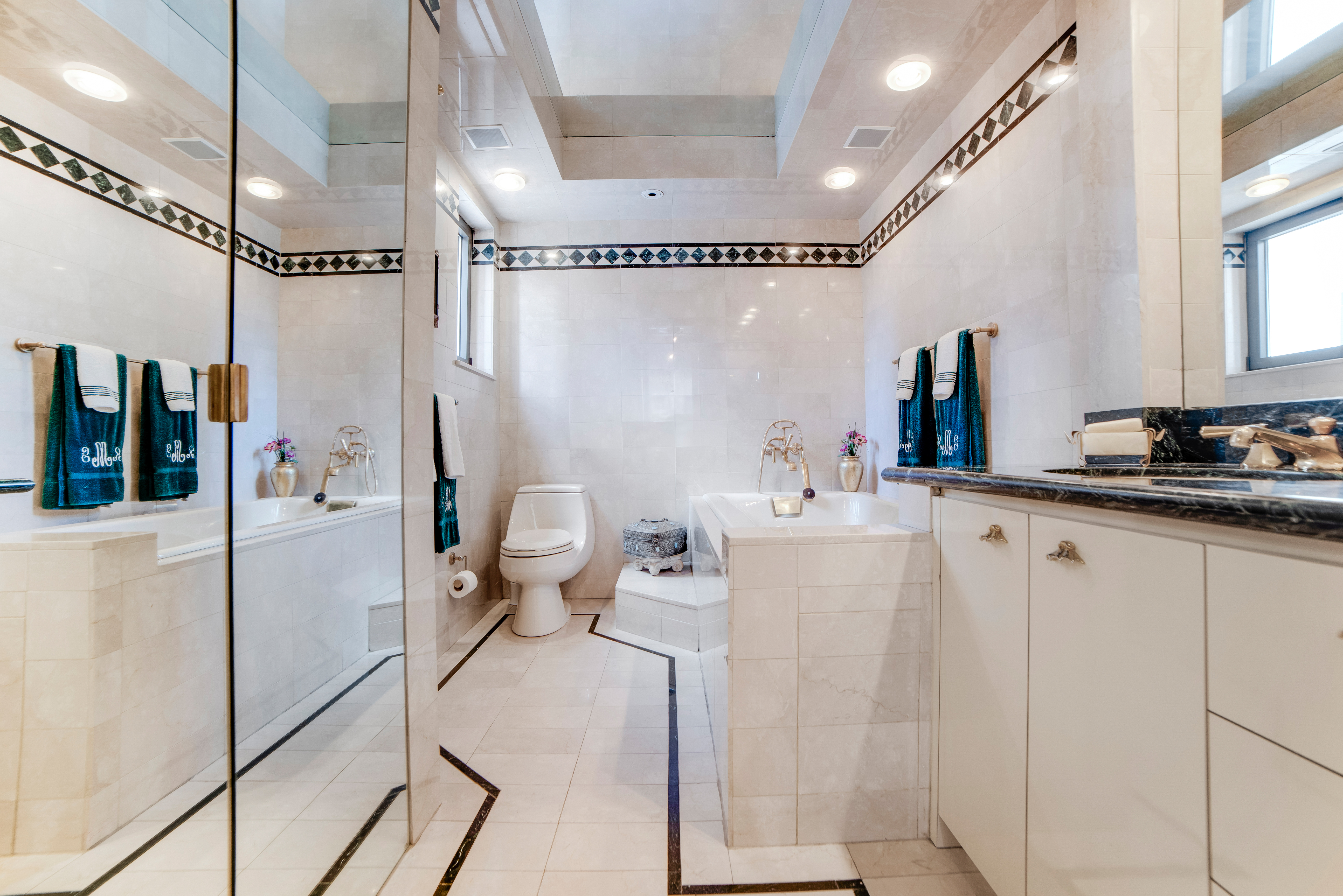 200 Central Park South, Unit 24A Manhattan, NY 10019 - Photo 17 of 23 a bathroom with a sink mirror vanity and toilet