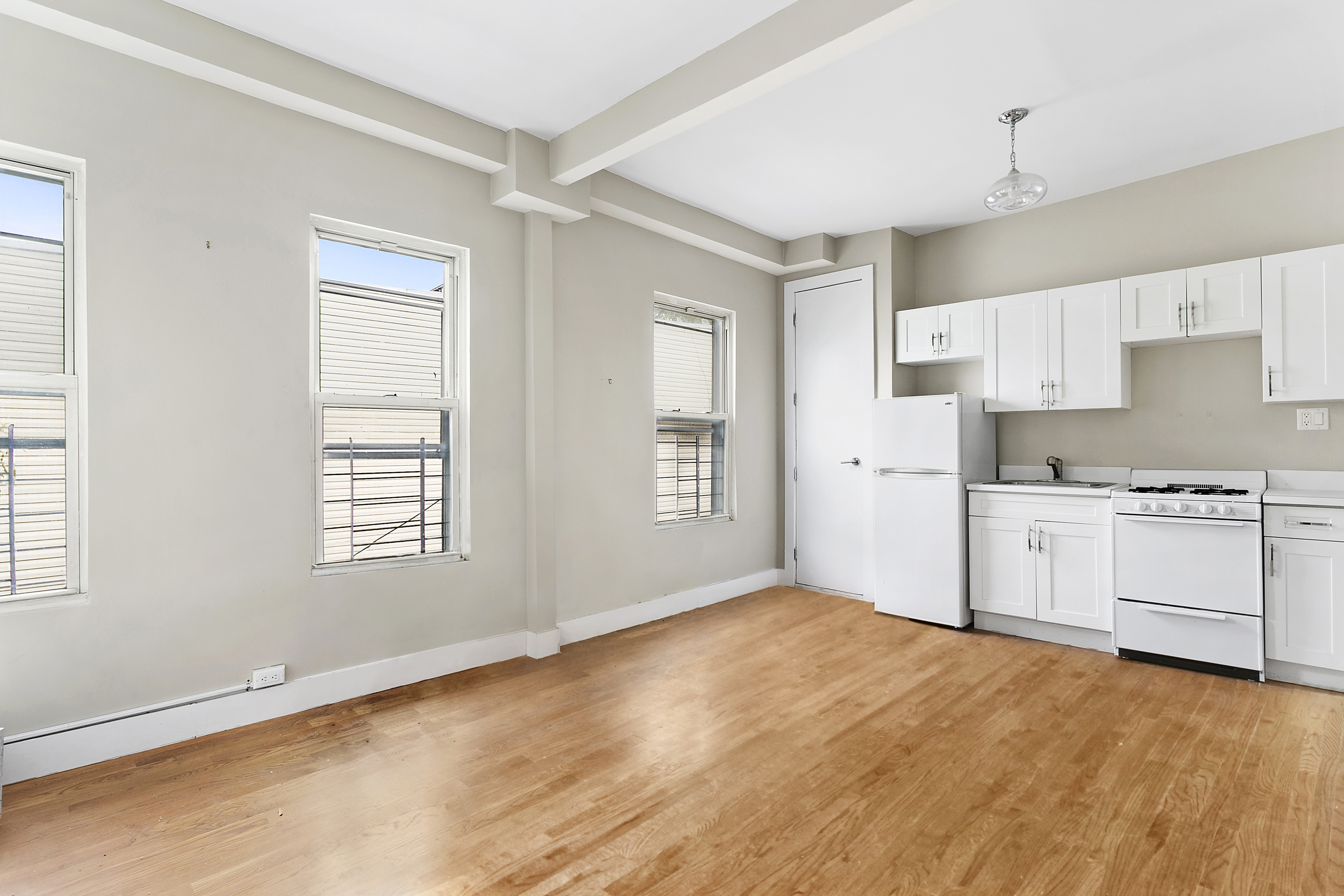 342 East 9th Street Brooklyn, NY 11218 - Photo 2 of 12 a view of a kitchen with wooden floor and a window