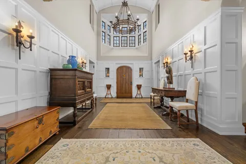 a living room with furniture fireplace and wooden floor