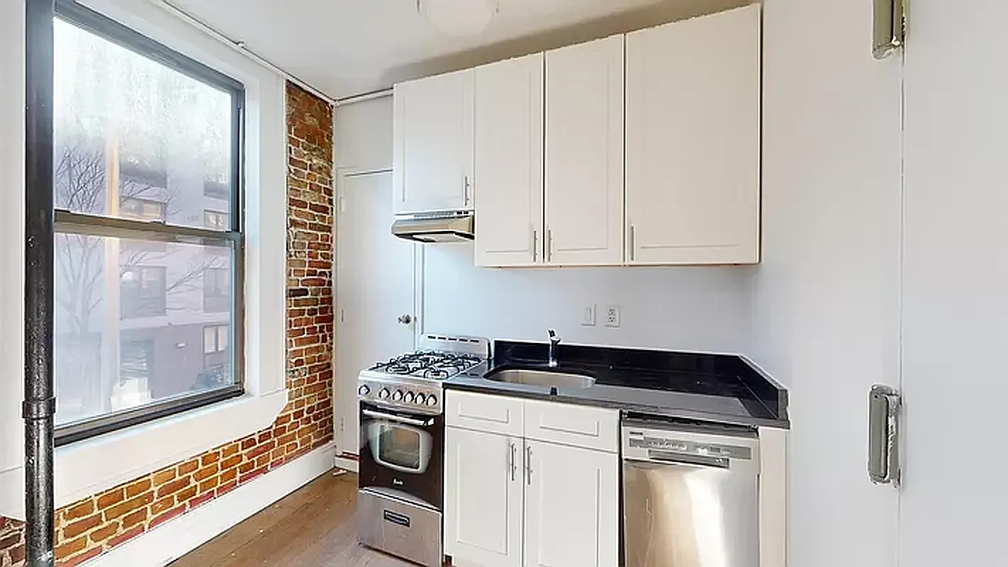 545 East 5th Street, Unit 3 Manhattan, NY 10009 - Photo 4 of 4 a kitchen with stainless steel appliances granite countertop a refrigerator and a stove