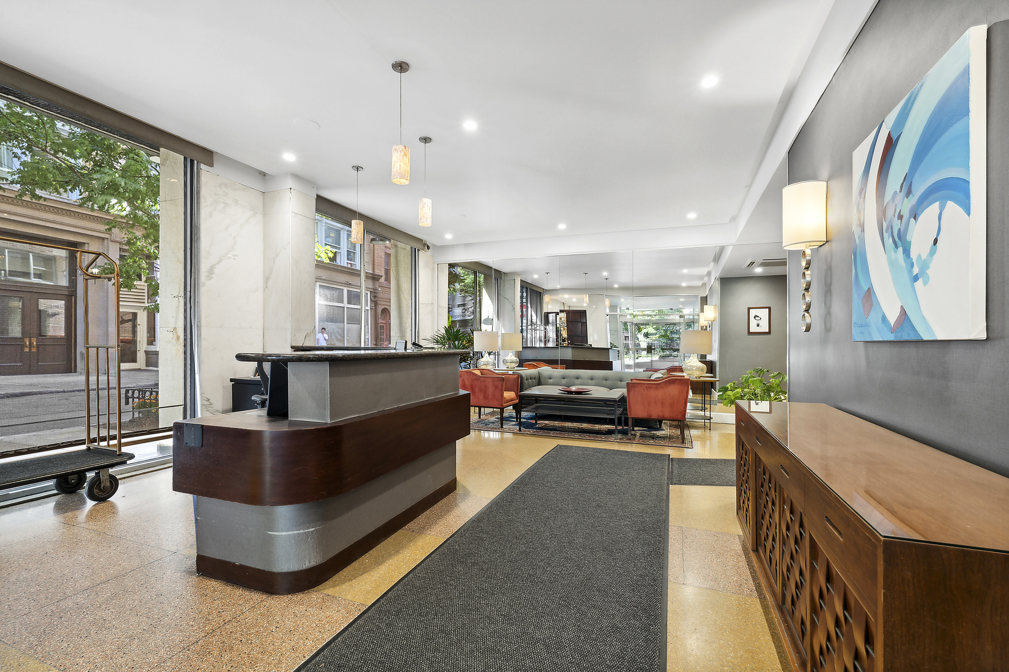 3 Sheridan Square, Unit 15A Manhattan, NY 10014 - Photo 10 of 11 a living room with furniture and a flat screen tv