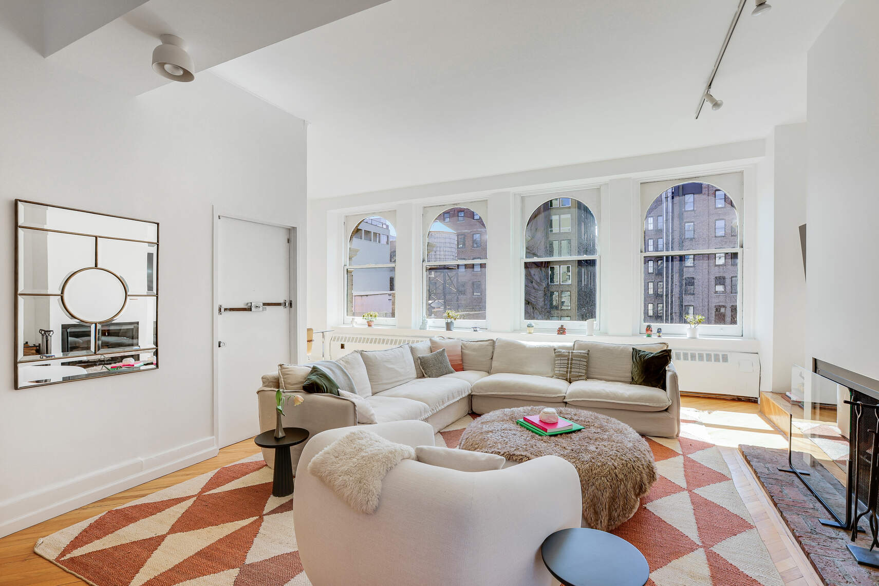 35 East 12th Street, Unit 8C Manhattan, NY 10003 - Photo 17 of 22 a living room with furniture wooden floor and a large window