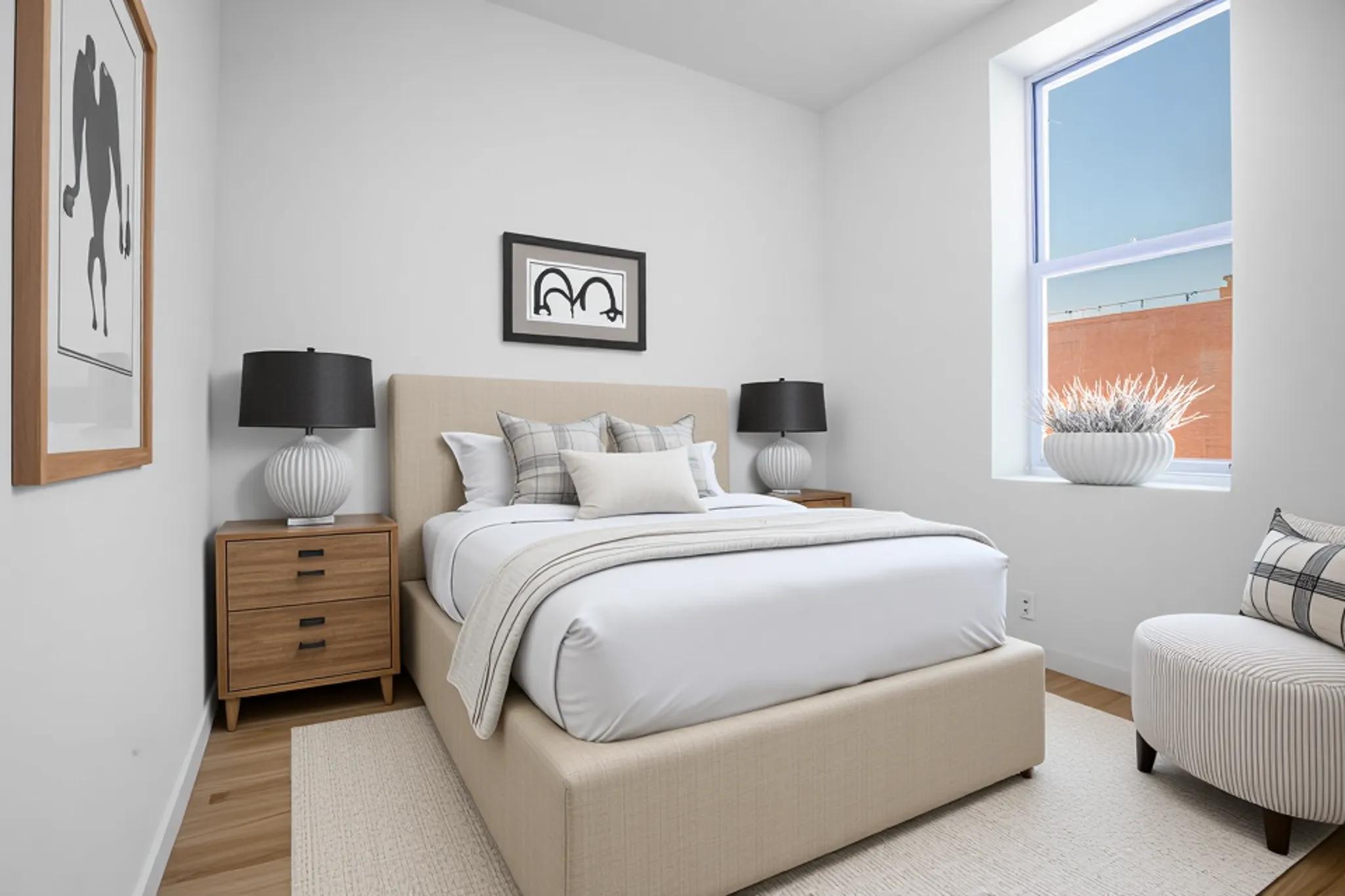 479 West 152nd Street, Unit 4C Manhattan, NY 10031 - Photo 10 of 23 a bedroom with a bed and a night stand