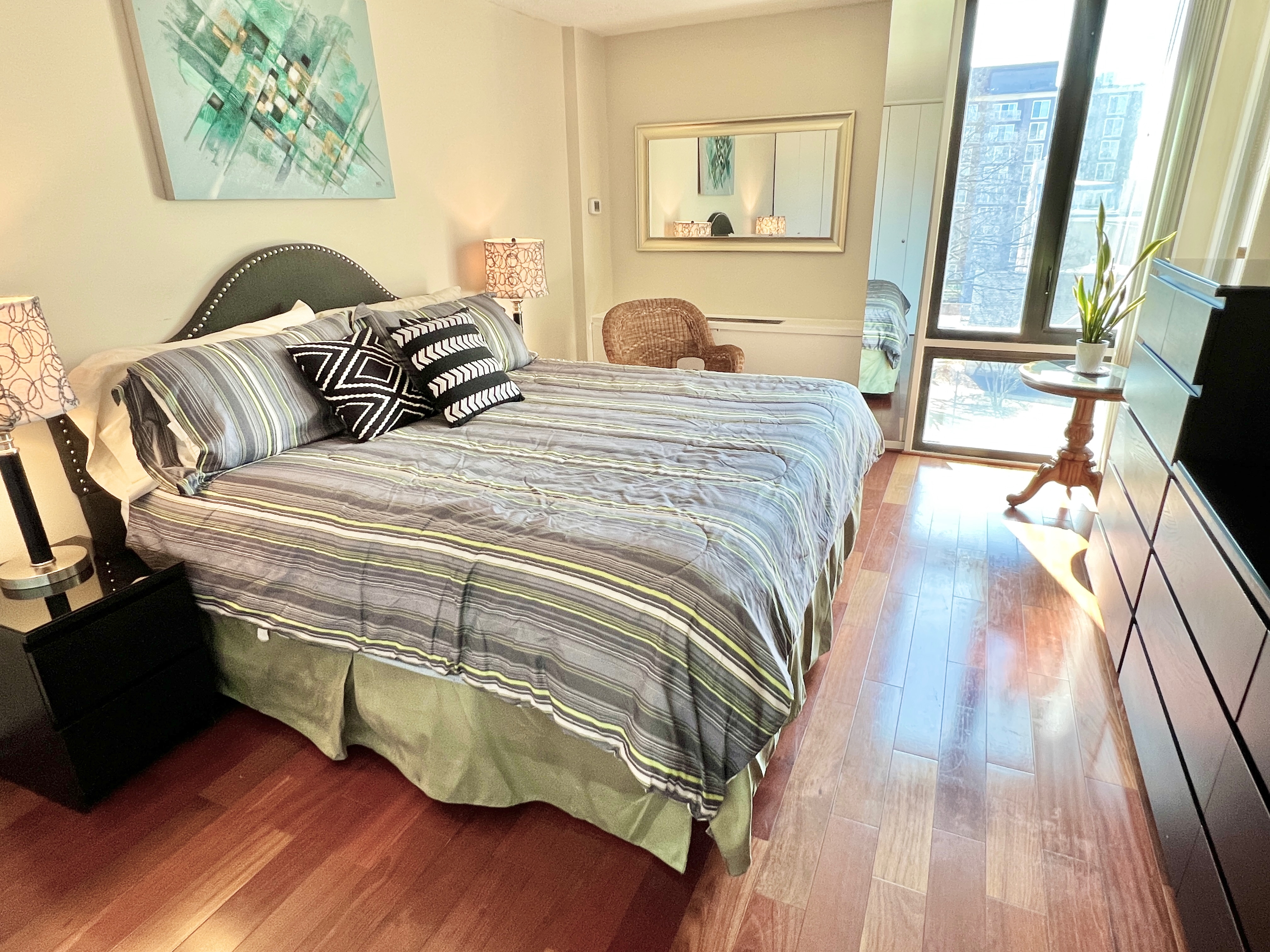 490 M Street Southwest, Unit W304 Washington, DC 20024 - Photo 19 of 36 a bedroom with a bed and wooden floor