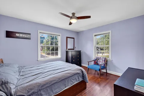 a bedroom with a bed a table and a window