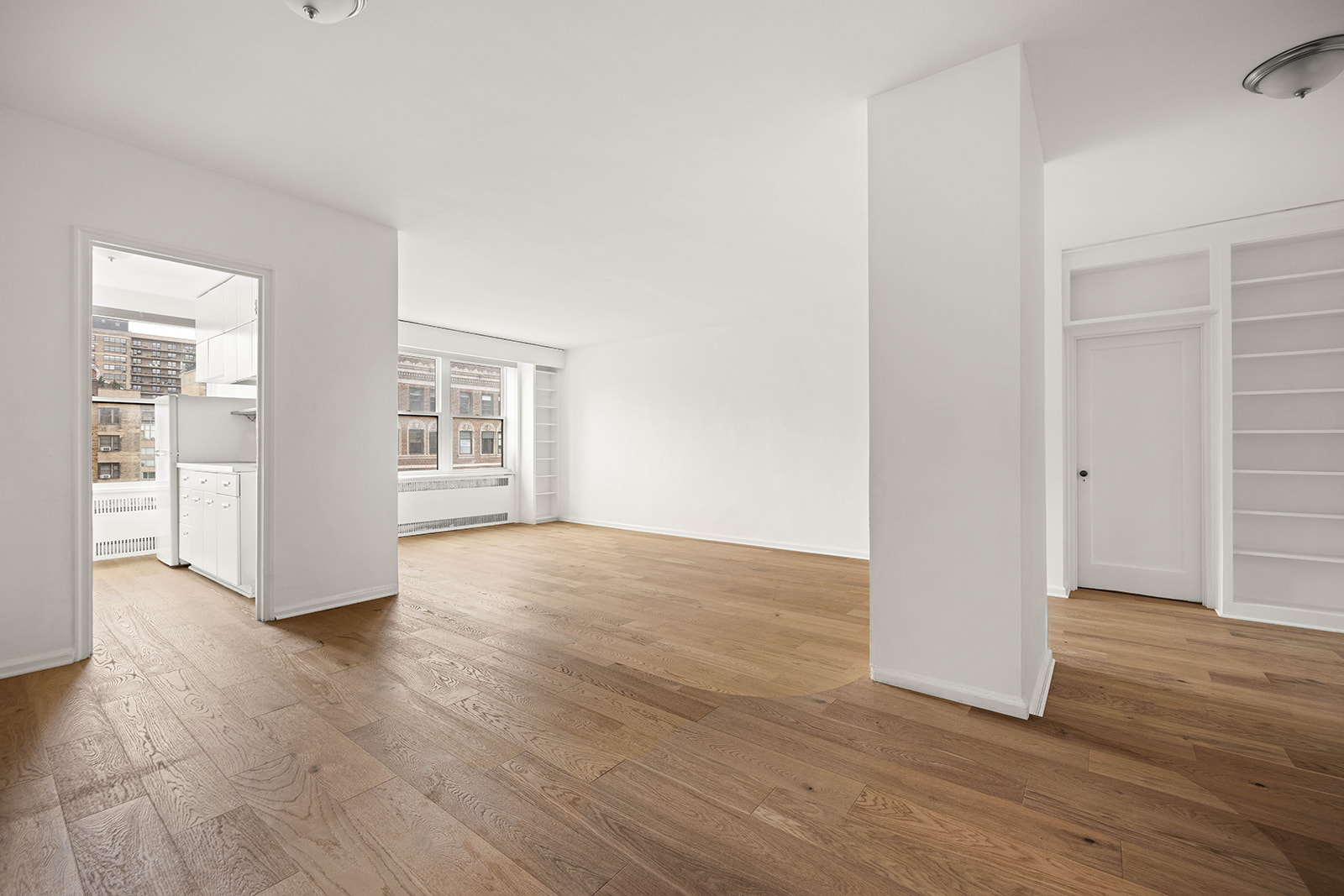 263 West End Avenue, Unit 13F Manhattan, NY 10023 - Photo 8 of 22 an empty room with wooden floor and windows