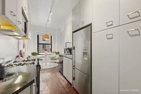 a kitchen with a refrigerator and a stove