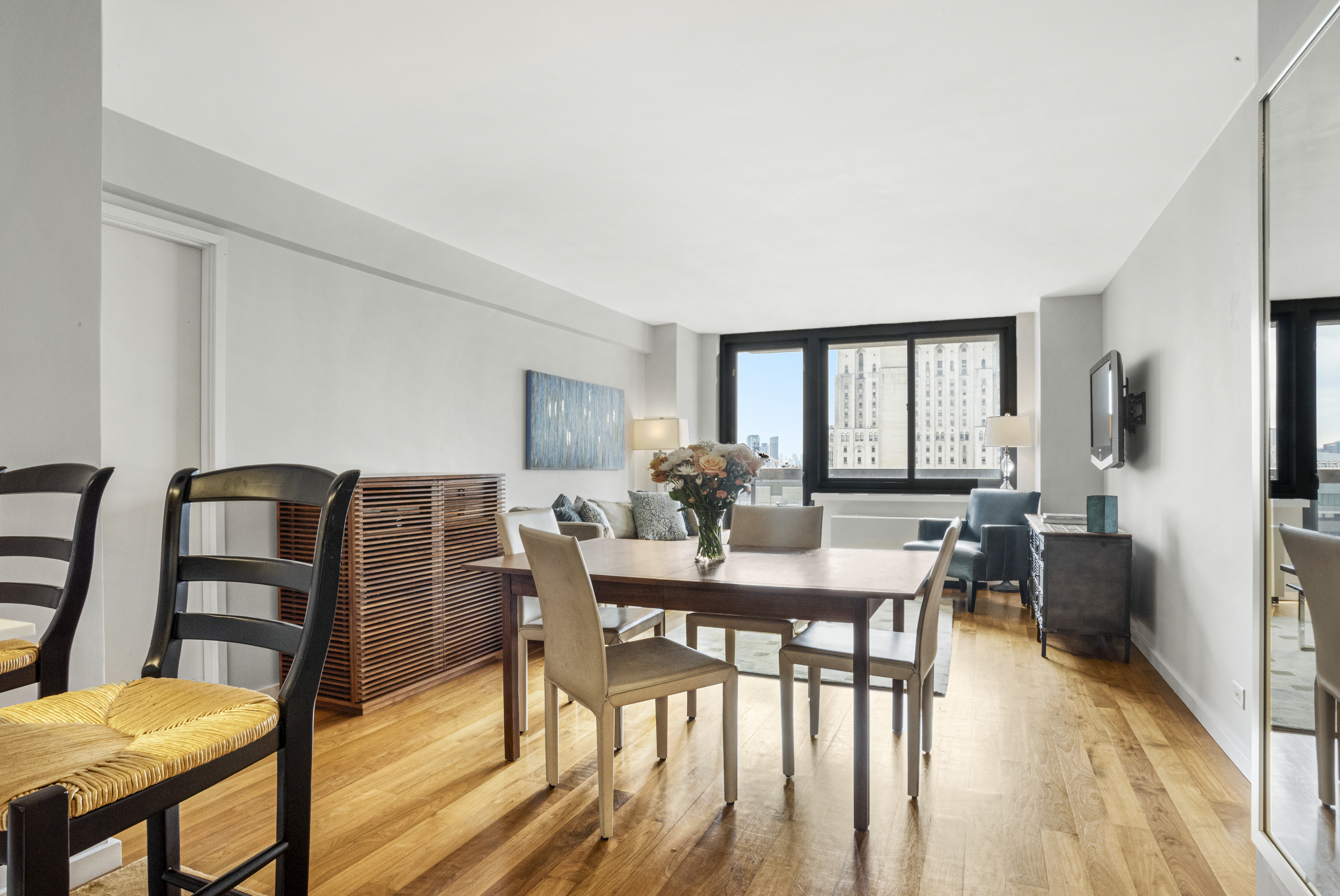 515 East 72nd Street, Unit 25E Manhattan, NY 10021 - Photo 2 of 11 a view of a dining room with furniture window and wooden floor