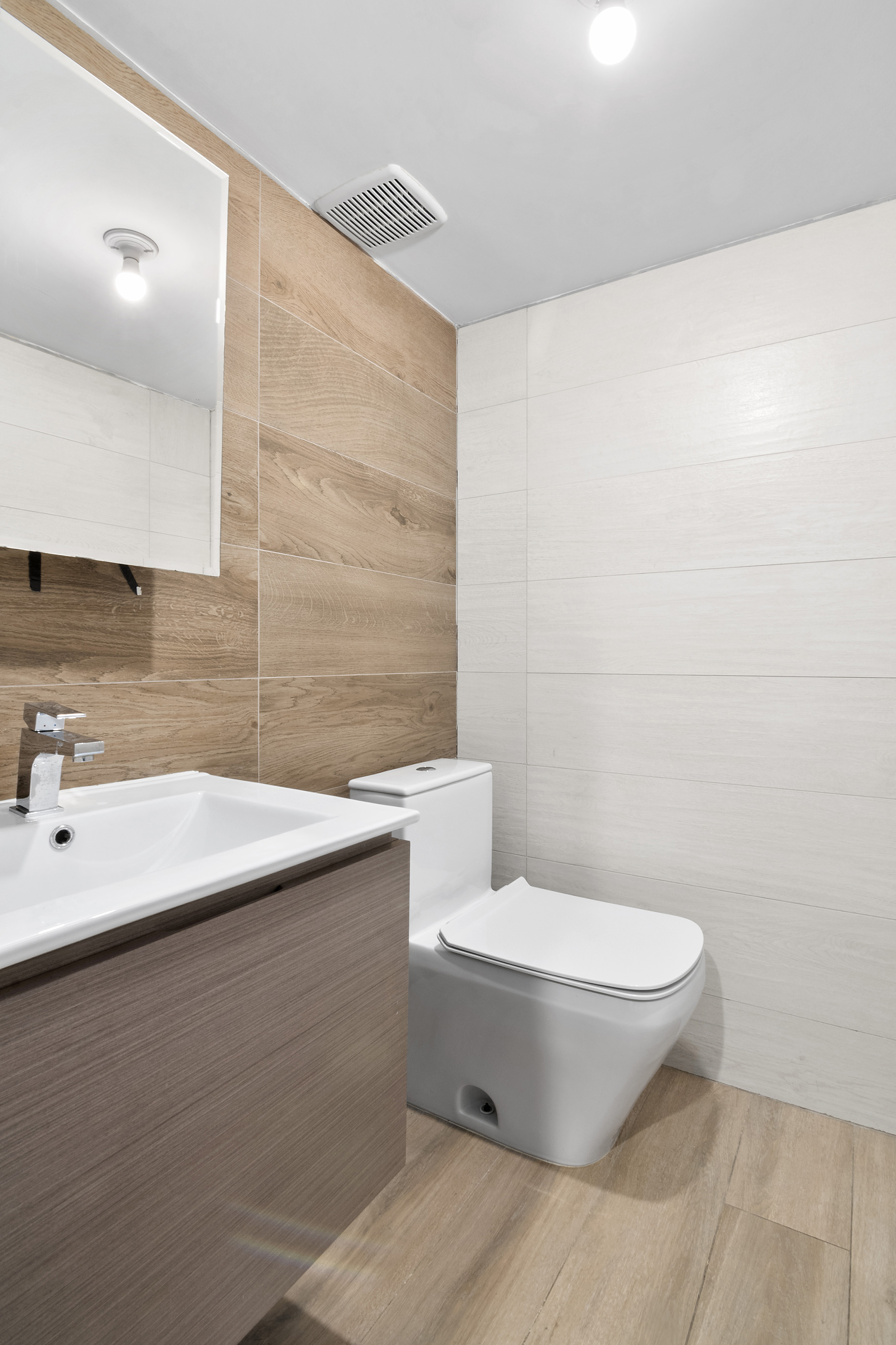 20-27 Menahan Street, Unit 1R Queens, NY 11385 - Photo 11 of 12 a bathroom with a sink and a toilet