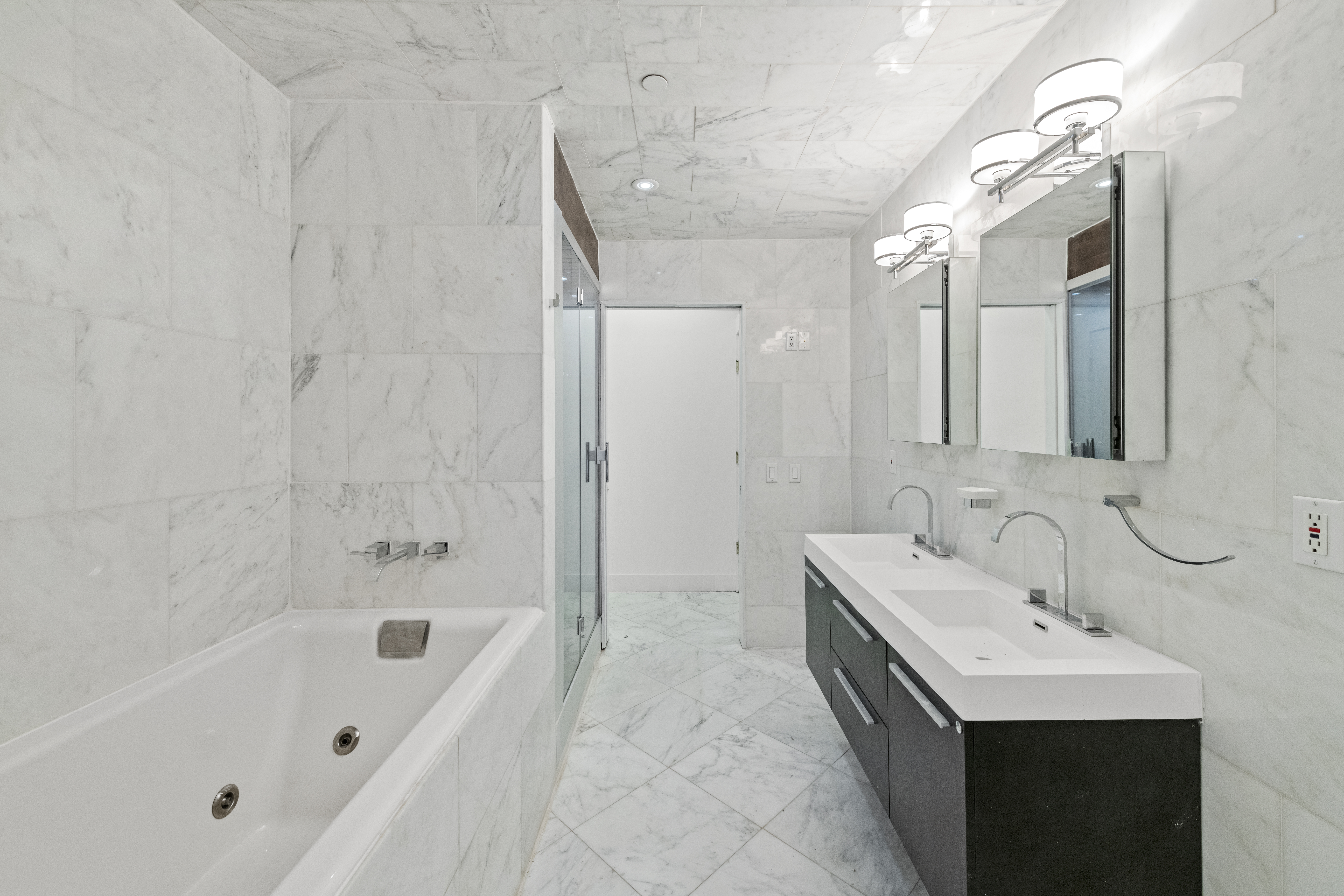 49 Walker Street, Unit PH Manhattan, NY 10013 - Photo 8 of 14 a bathroom with a tub sink and mirror