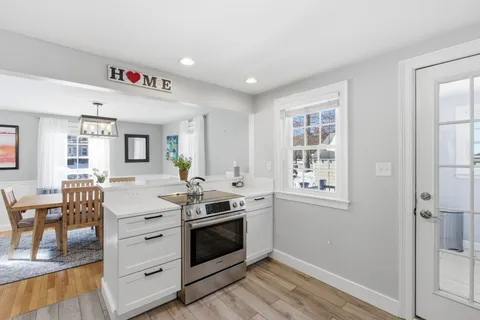 a kitchen with granite countertop a stove and cabinets