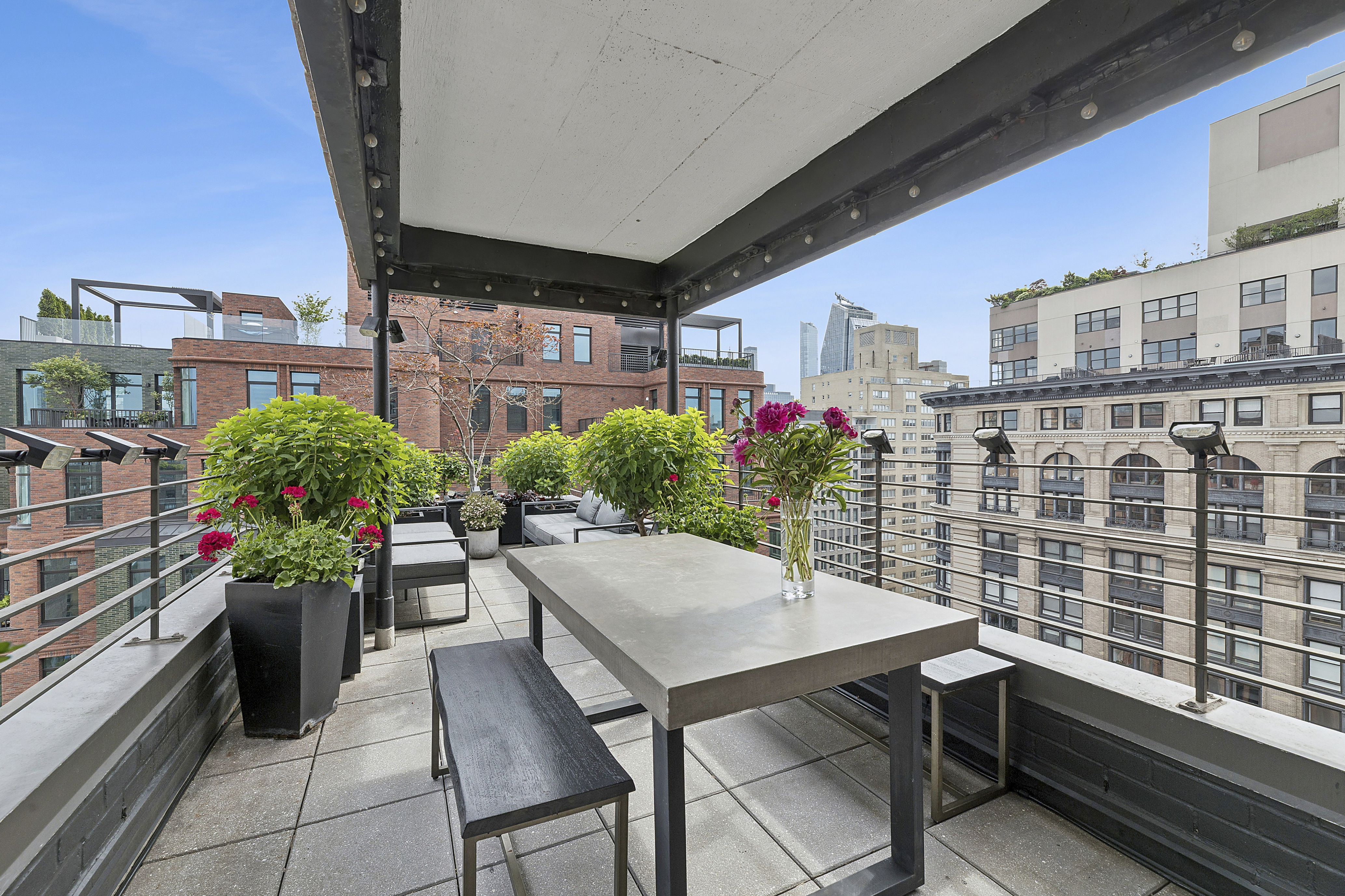 105 West 13th Street, Unit 16F Manhattan, NY 10011 - Photo 7 of 12 a patio with table and chairs and potted plants