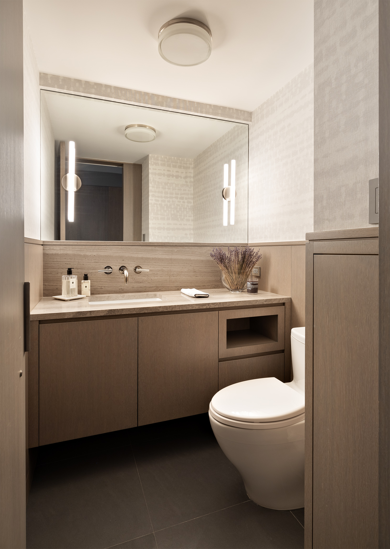 45 East 72nd Street, Unit 9C Manhattan, NY 10021 - Photo 15 of 16 a bathroom with a granite countertop toilet sink and mirror