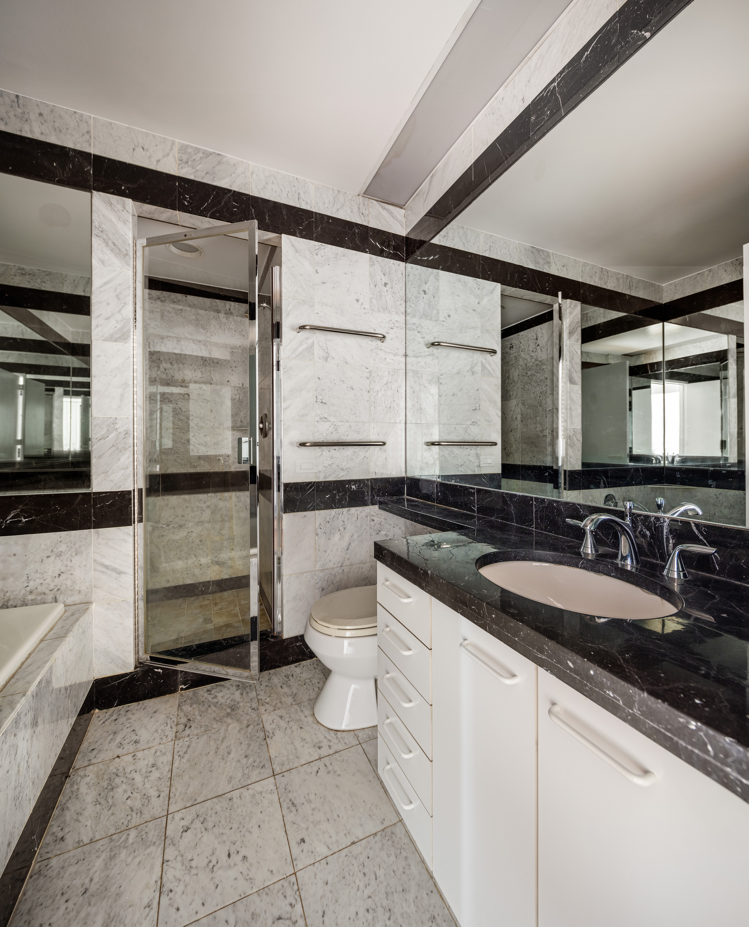 150 West 56th Street, Unit 6205 Manhattan, NY 10019 - Photo 5 of 6 a bathroom with a sink and a mirror