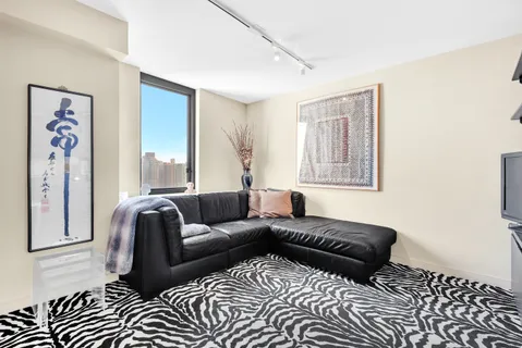 a living room with a couch and a window
