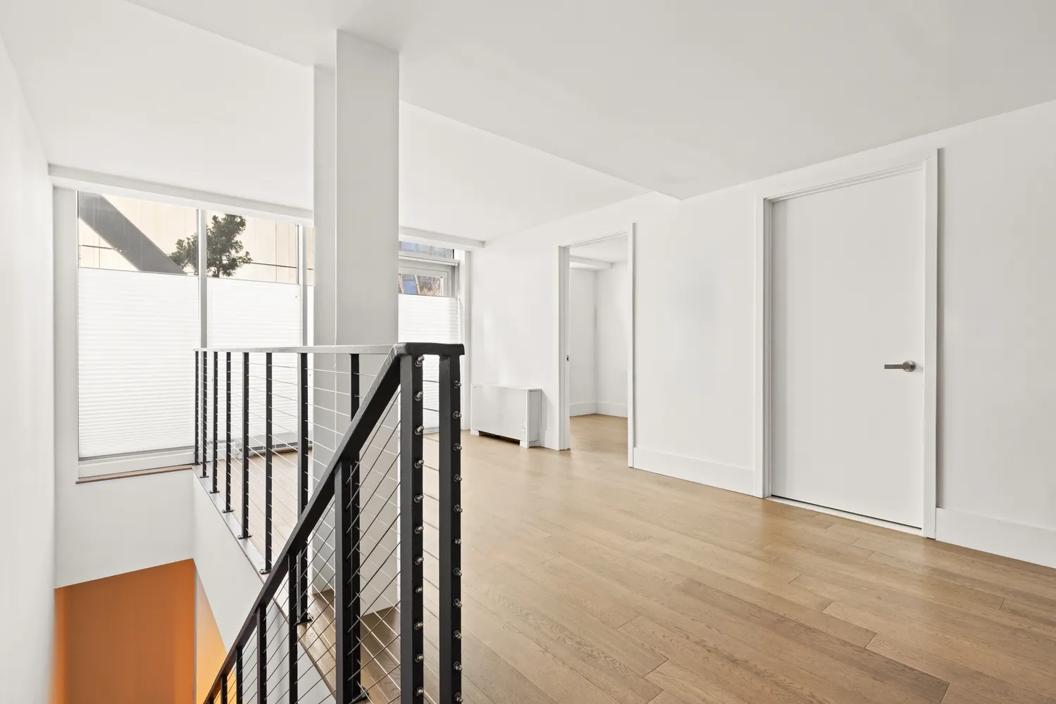 a view of an entryway with wooden floor